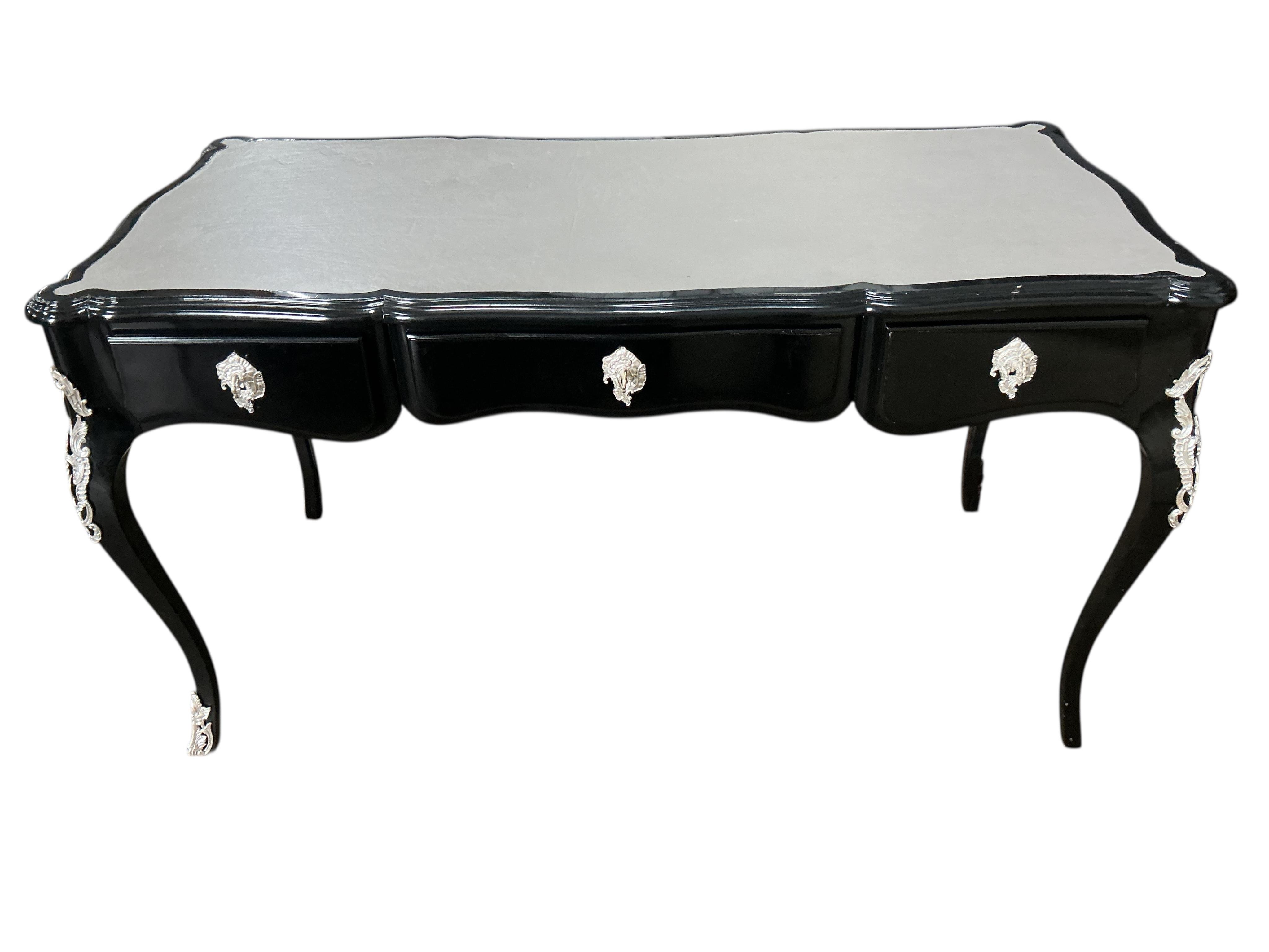 A Contemporary Louis XVI style ebonised bureau plat, width 146cm, depth 71cm, height 79cm